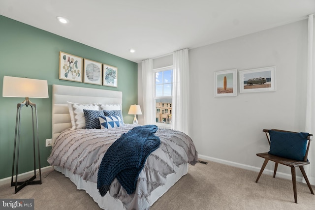 bedroom with baseboards, recessed lighting, visible vents, and light colored carpet