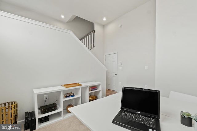 office with light carpet, a high ceiling, and recessed lighting