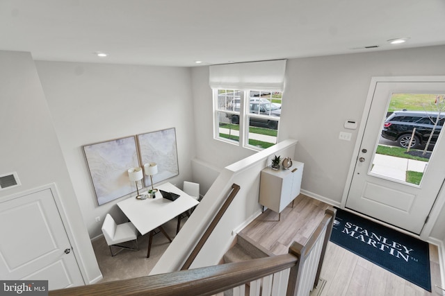 foyer entrance featuring visible vents, baseboards, light wood-style flooring, and recessed lighting