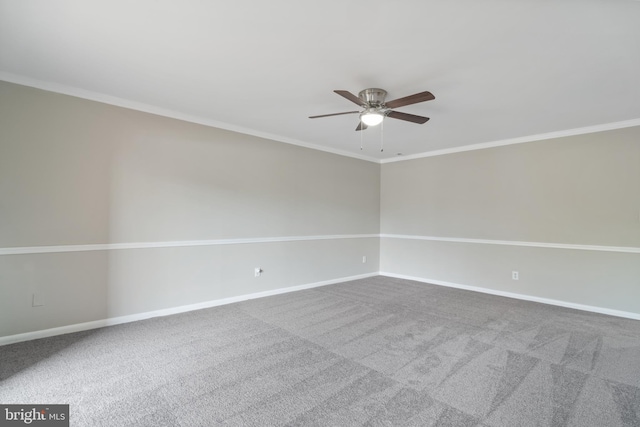 carpeted spare room with crown molding and ceiling fan