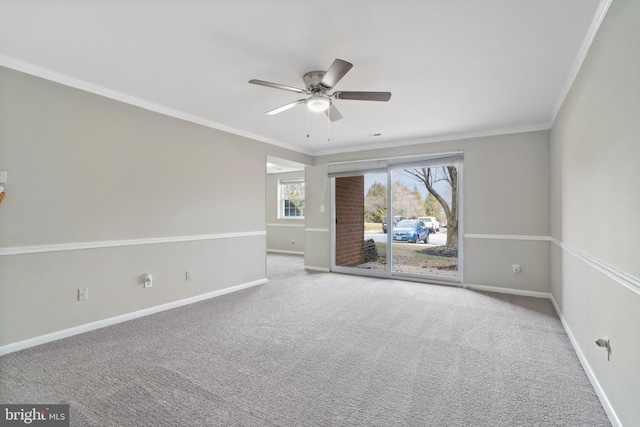 empty room with carpet floors, ornamental molding, and ceiling fan