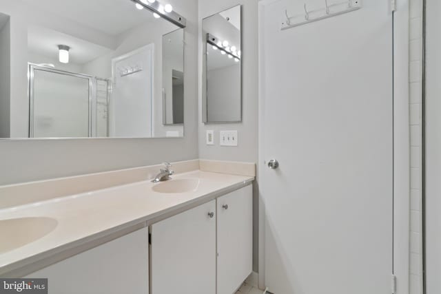 bathroom with walk in shower and vanity