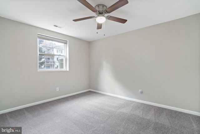 carpeted spare room with ceiling fan