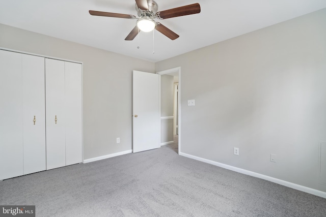 unfurnished bedroom with light carpet, a closet, and ceiling fan