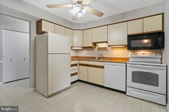 kitchen featuring ceiling fan, cream cabinets, sink, and white appliances