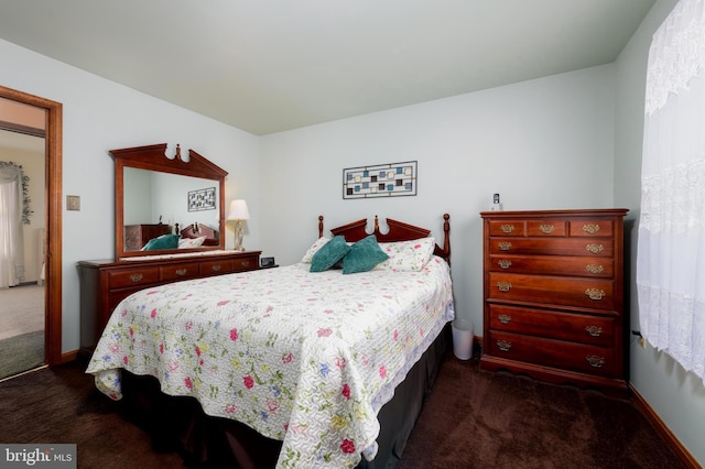 bedroom featuring dark colored carpet