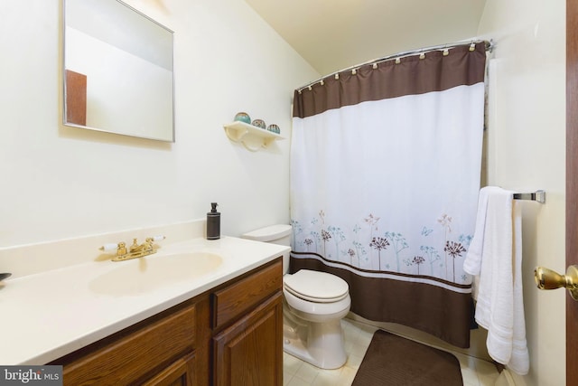 bathroom featuring toilet, vanity, and walk in shower