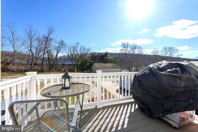 wooden deck with a grill