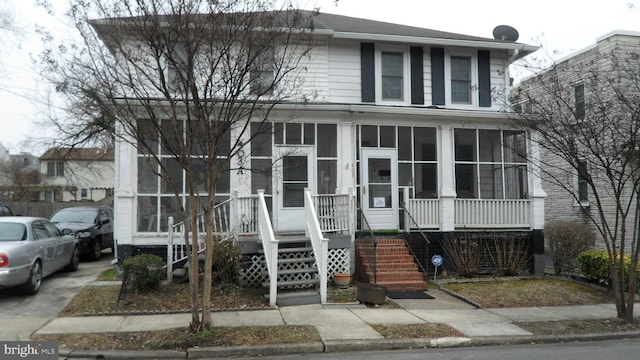 view of front of house with a sunroom