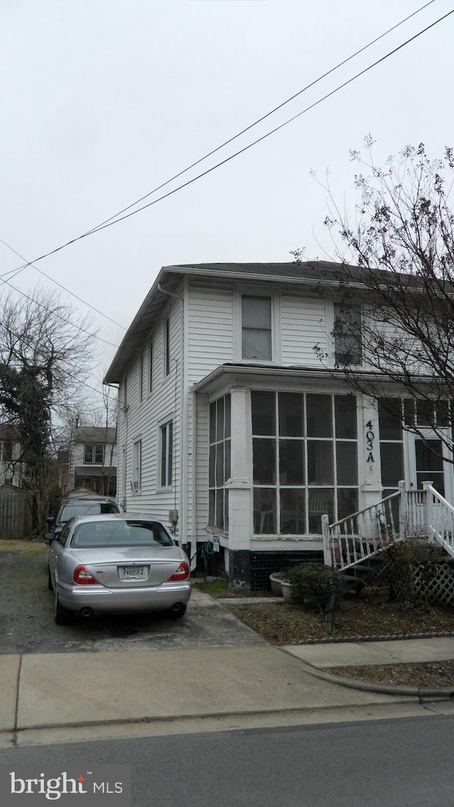 view of front of property with a sunroom