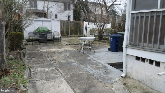 view of patio with a storage shed