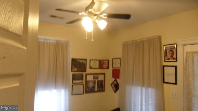 interior space with ceiling fan