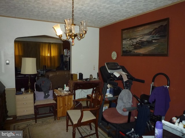 dining space with crown molding, a chandelier, and a textured ceiling