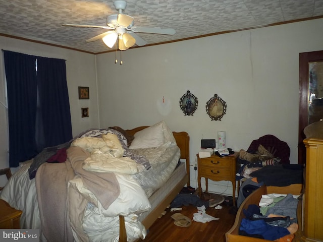 bedroom featuring crown molding, hardwood / wood-style floors, and ceiling fan