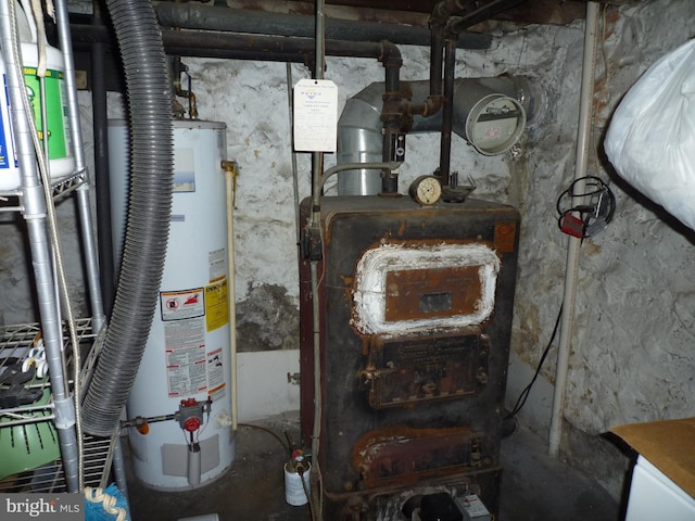 utility room featuring water heater