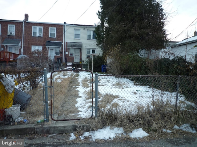 view of snow covered back of property