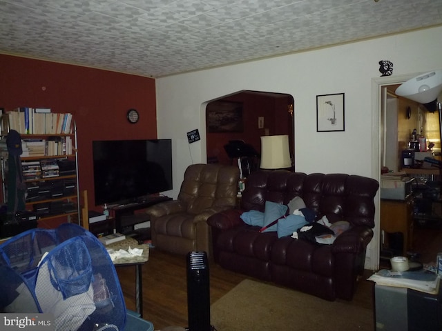 living room with wood-type flooring and a textured ceiling