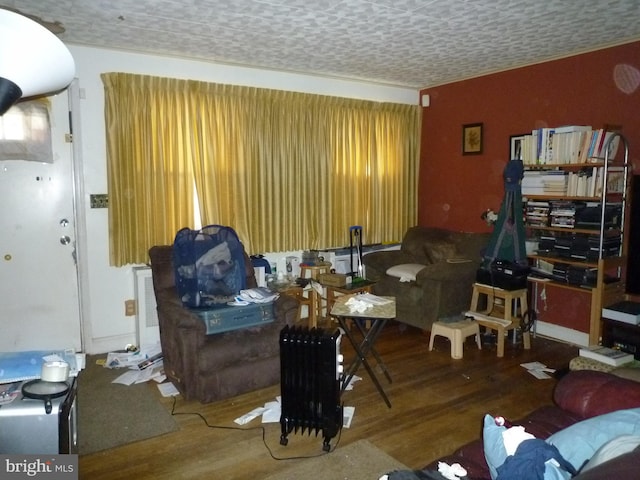 living room with hardwood / wood-style flooring and a textured ceiling