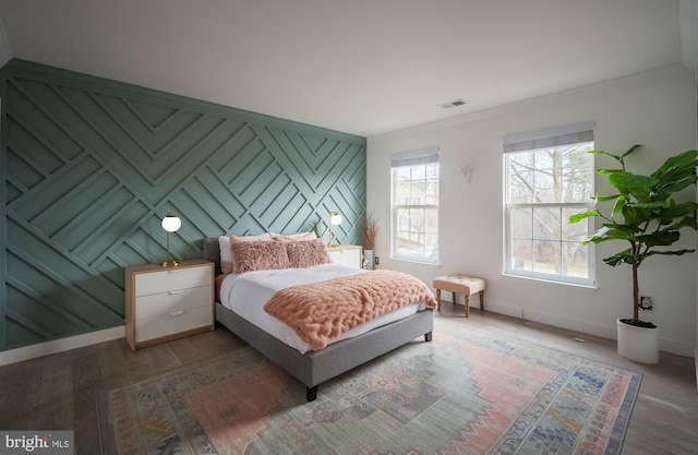 bedroom featuring dark wood-type flooring and ornamental molding