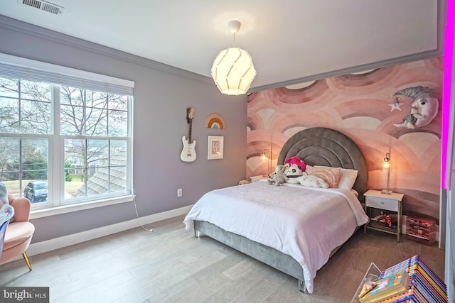 bedroom featuring crown molding, hardwood / wood-style floors, and multiple windows