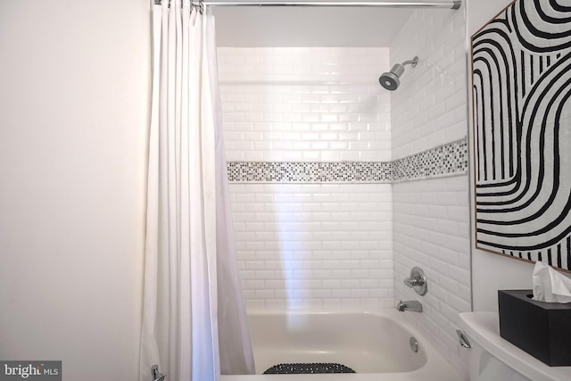 bathroom with toilet and shower / bath combo with shower curtain