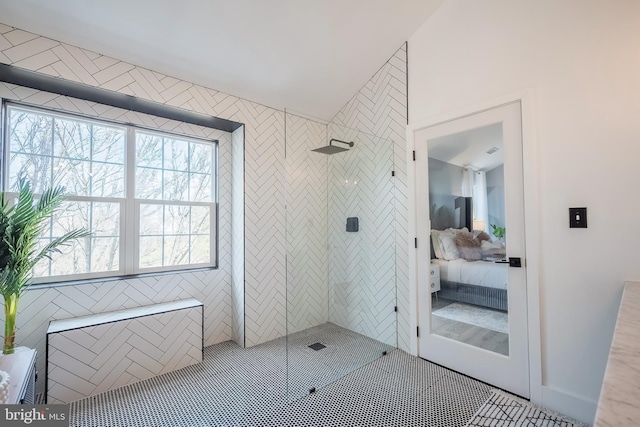 bathroom featuring a tile shower, tile patterned floors, and a healthy amount of sunlight