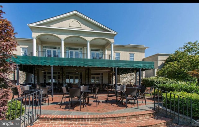 exterior space with a balcony and french doors