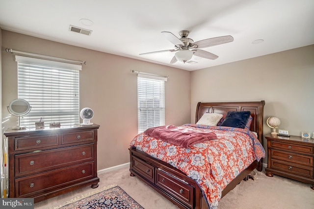 bedroom featuring ceiling fan and light carpet