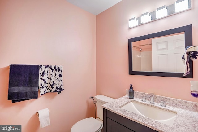 bathroom with vanity, toilet, and walk in shower