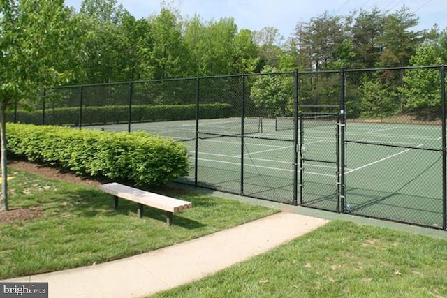 view of tennis court with a lawn