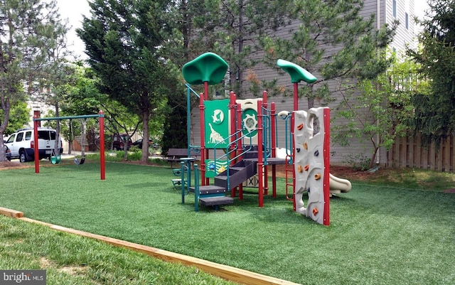 view of jungle gym featuring a lawn