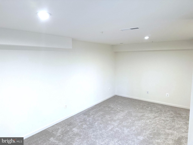 carpeted empty room with baseboards and visible vents