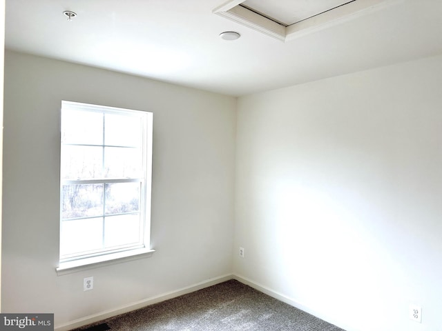 unfurnished room with carpet flooring and baseboards