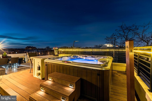 wooden deck with a hot tub