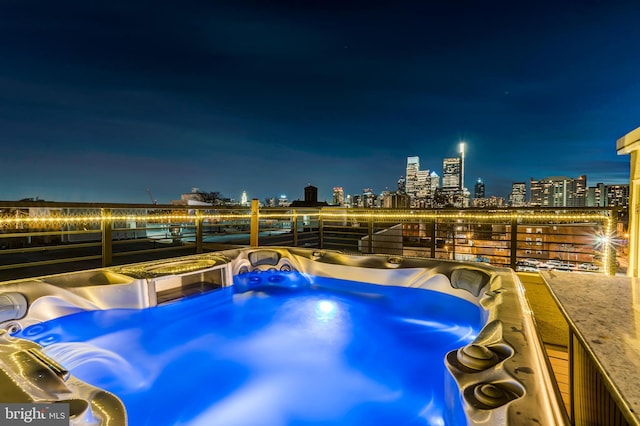 pool at twilight with a hot tub