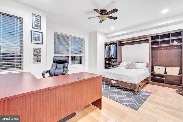 bedroom with ceiling fan and light hardwood / wood-style flooring