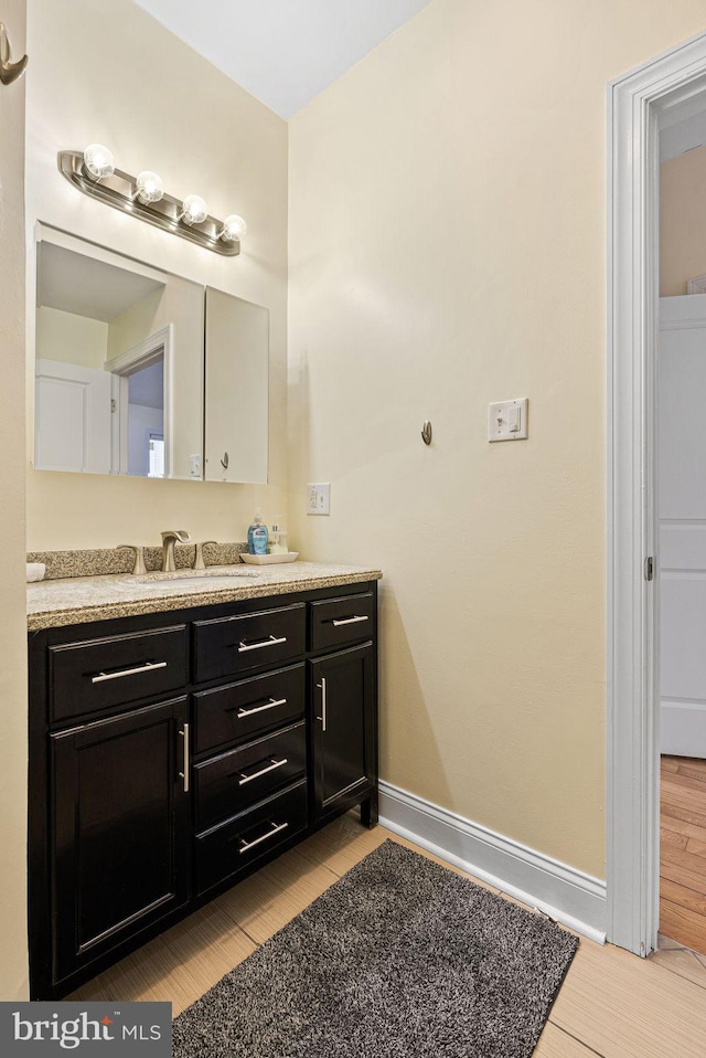 bathroom with vanity and hardwood / wood-style floors