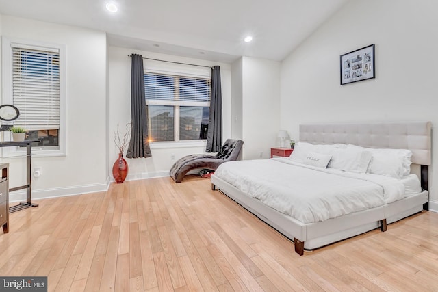 bedroom featuring lofted ceiling and light hardwood / wood-style flooring