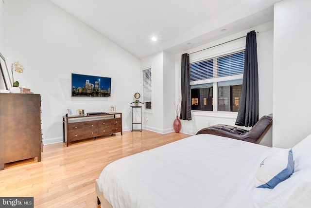 bedroom with hardwood / wood-style flooring and vaulted ceiling