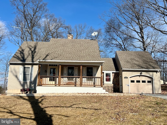 view of front of property with a garage, covered porch, and a front yard