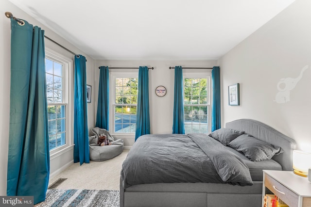 bedroom with baseboards, visible vents, and carpet flooring