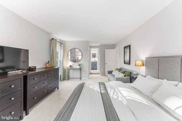 bedroom featuring light carpet and baseboards