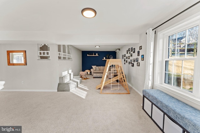 game room with baseboards and carpet flooring