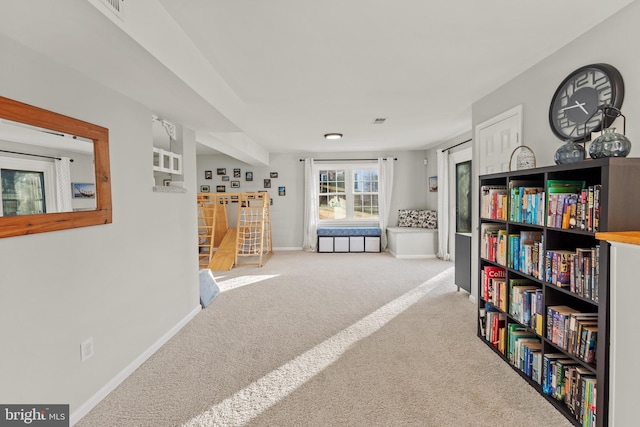 sitting room featuring carpet floors and baseboards