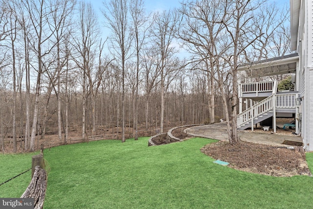 view of yard featuring stairway and a wooden deck