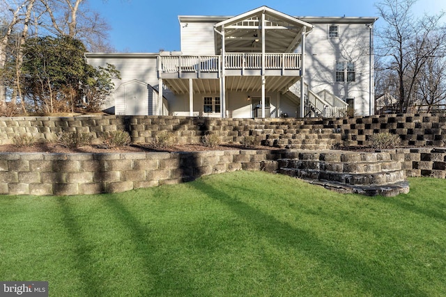 back of house with ceiling fan, a yard, stairway, and a wooden deck