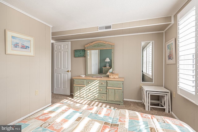 carpeted bedroom with crown molding and multiple windows