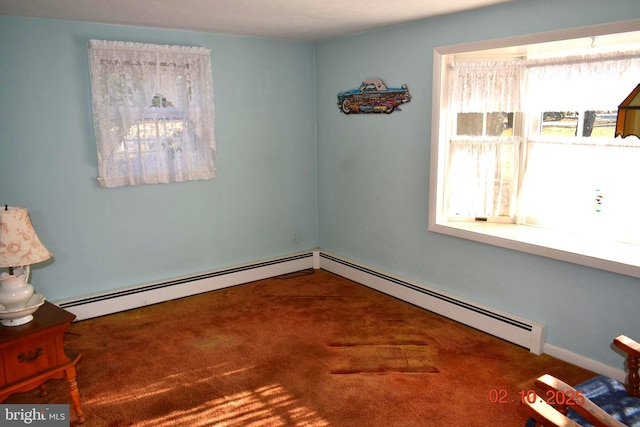 carpeted spare room featuring a baseboard heating unit