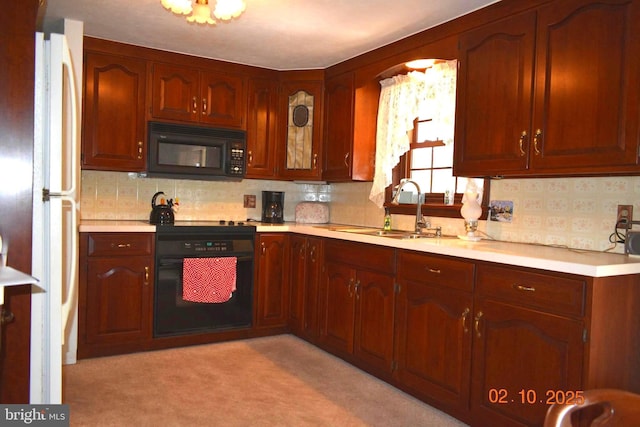 kitchen featuring tasteful backsplash, sink, oven, and white fridge