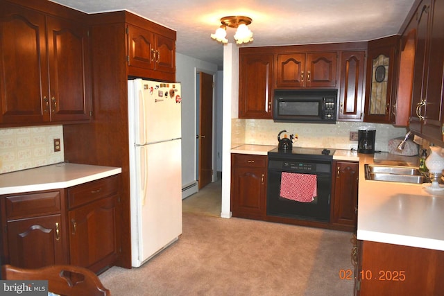 kitchen featuring sink, white refrigerator, decorative backsplash, a baseboard radiator, and oven